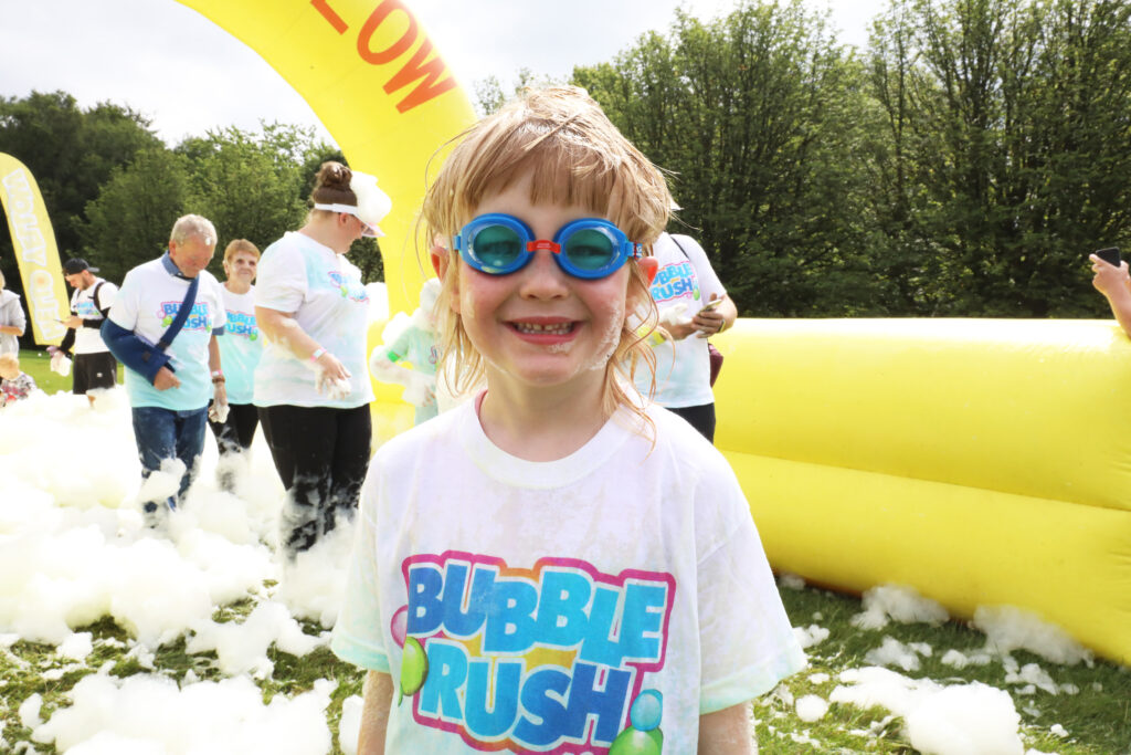 Smiling Happy Child with Goggles at Bubble Rush 5K Fun-Run