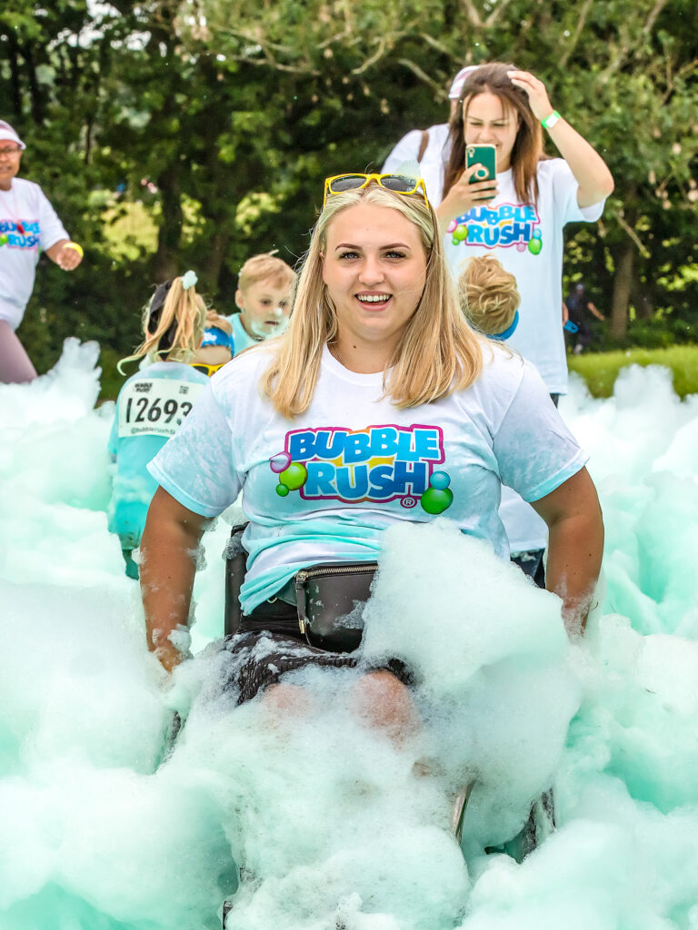 Woman Happy Taking Part In Bubble Rush In Her Wheelchair